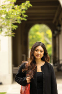 Photo of a woman in front of an arch