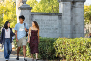 Students walking through stone gates