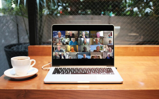 A laptop screen showing a group of Pomona alums