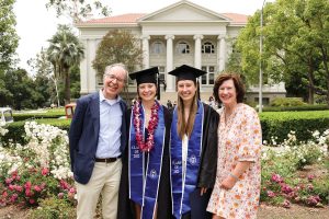 Emma Paulini, originally Class of ‘21, and her sister Helen Paulini ‘22, right, graduated together after Emma took a gap year due to the pandemic. They’re flanked by their parents, Manfred and Ann.