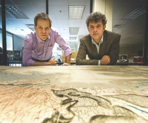 Professors Robert Gaines and Jade Star Lackey lean over the map